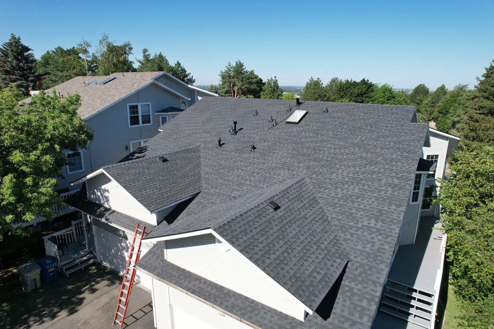 Drone view of a finished gray asphalt shingle roof with multiple gables on a house in Boise, installed by Bork Roofing.