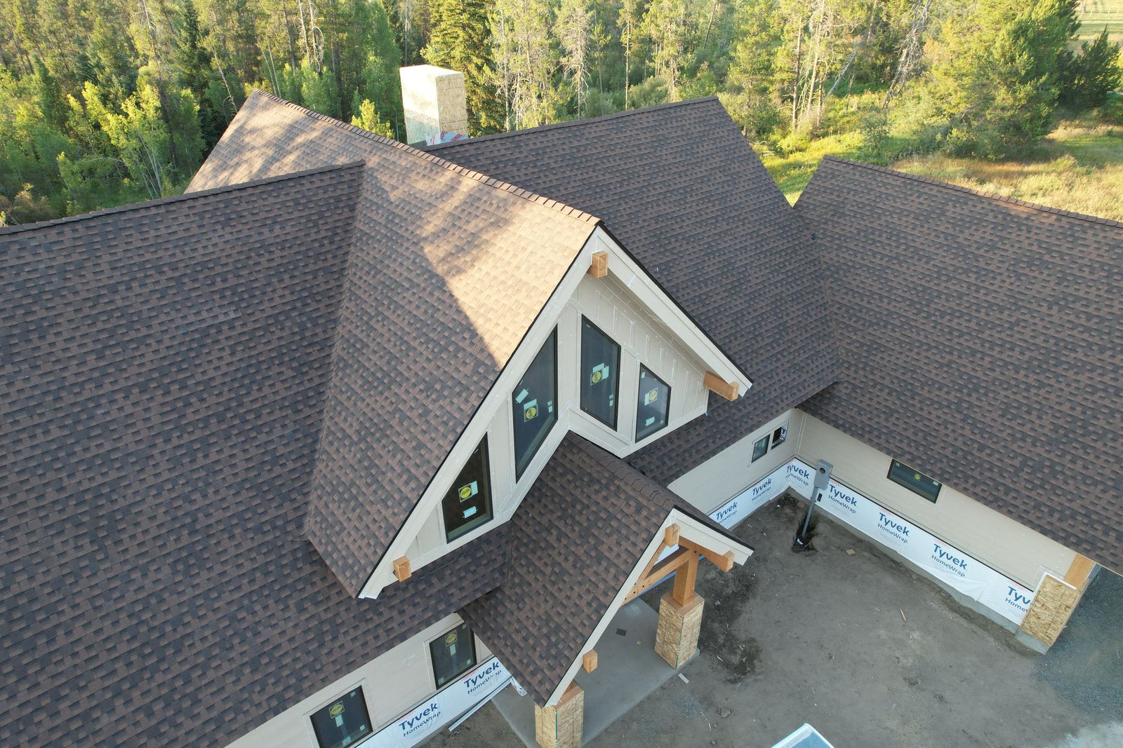 Brown asphalt shingle roof and front dormer on a new home in Donnelly, Idaho, installed by Bork Roofing.