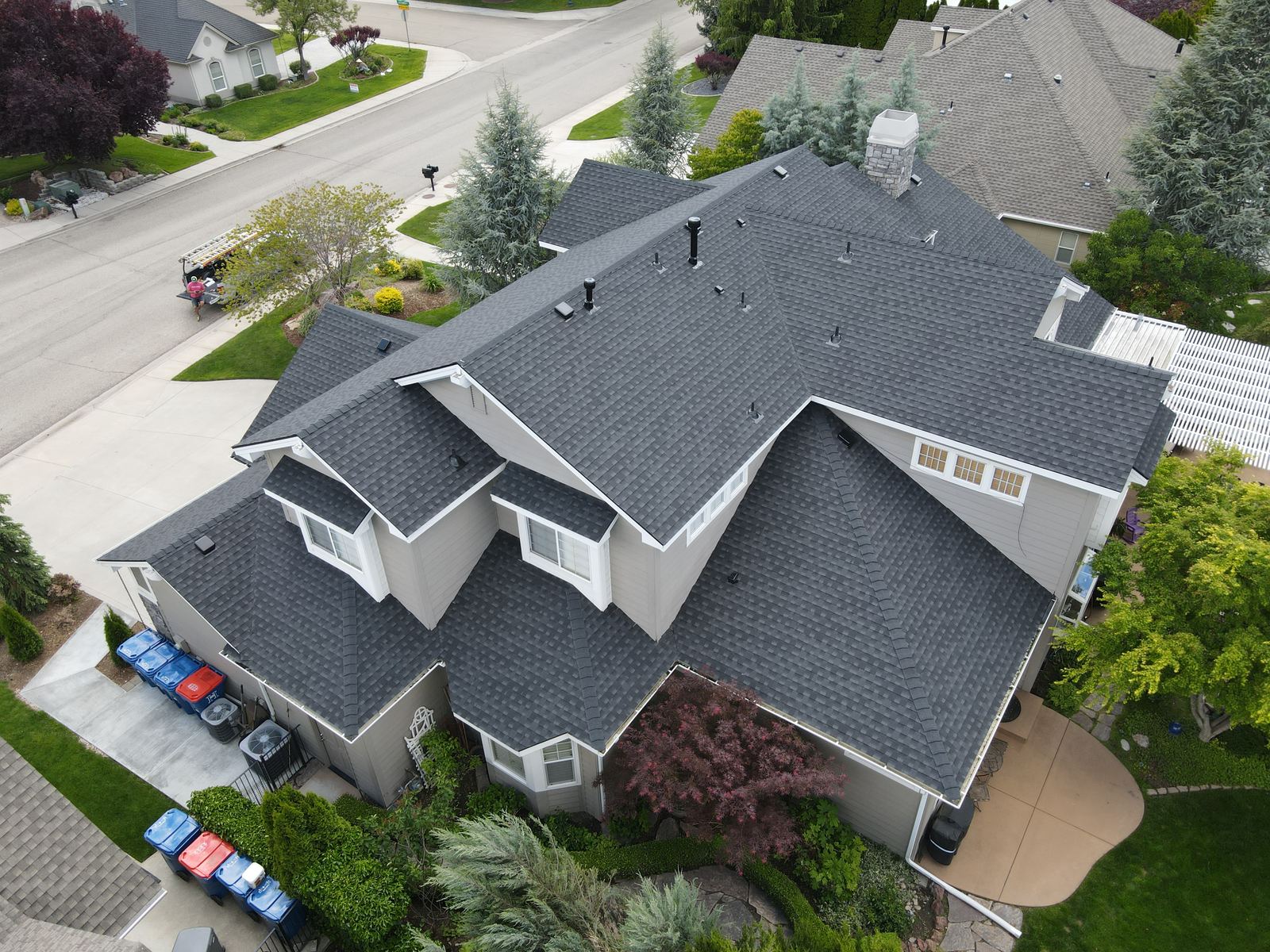 Drone view of a large Meridian home with a charcoal asphalt shingle roof, installed by Bork Roofing.